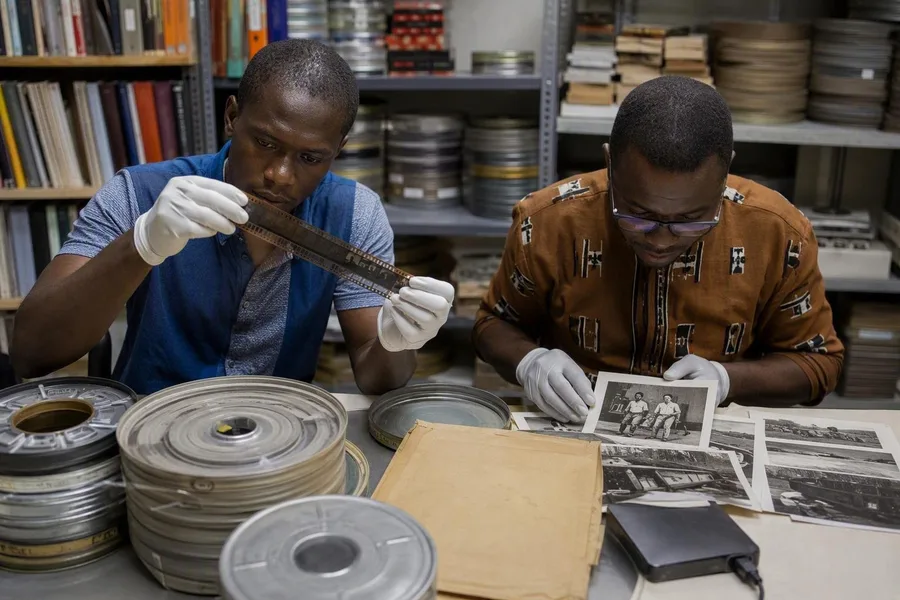 Medewerkers digitaliseren filmrollen en catalogiseren foto’s bij de Cinémathèque africaine de Ouagadougou.