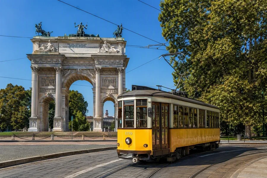 Tramlijn 1 stopt naast Parco Sempione onder de Arco della Pace in Milaan.